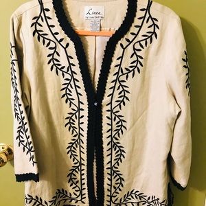 Tan jacket with black embroidery.